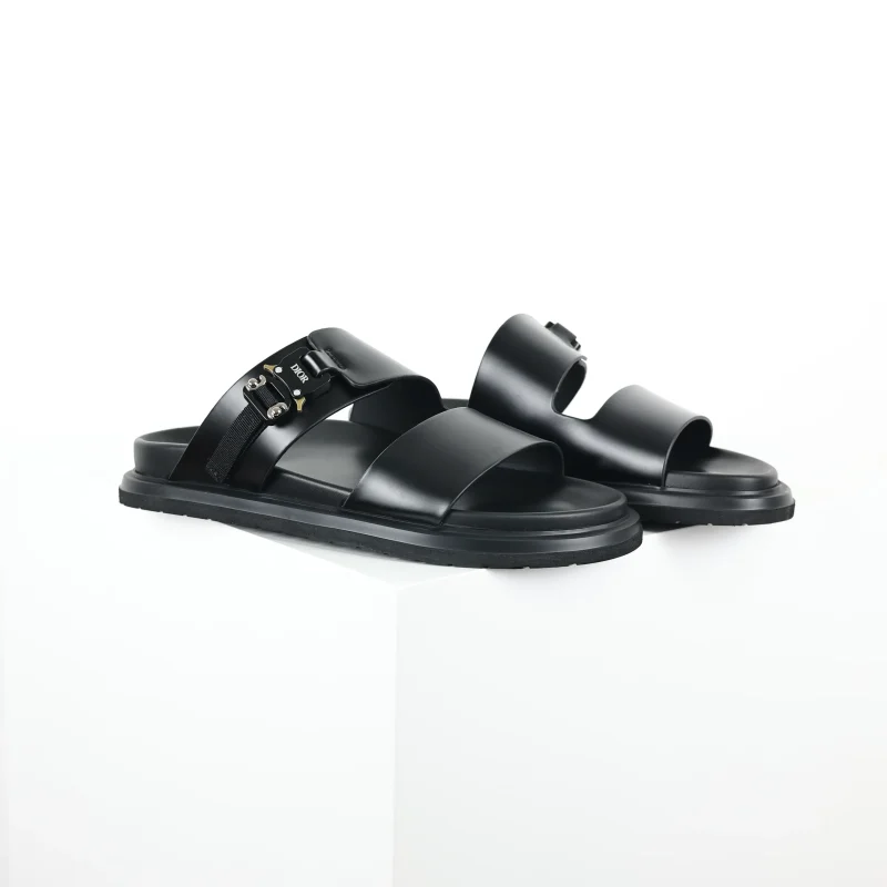 Aqua-colored, flat leather slippers with a round toe in black
